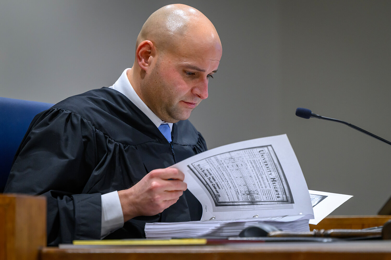 Judge Derek A. Ankrom scrutinizes a binder of exhibits during a Dec. 27 hearing in a case regarding a proposed University Heights development. 